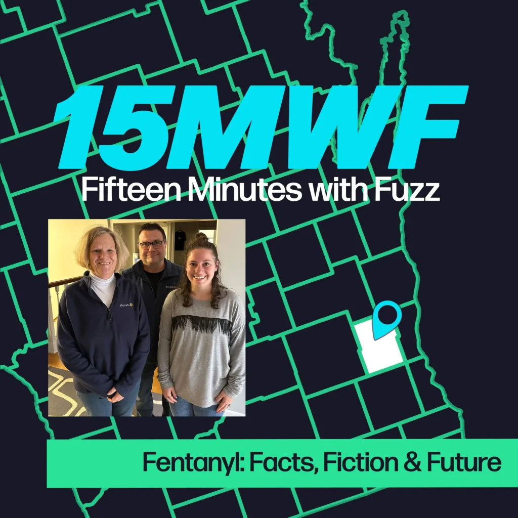 A graphic for “Fifteen Minutes with Fuzz” features a background map outline in green on a dark blue background. The title “15MWF” in large teal letters is at the top, with “Fifteen Minutes with Fuzz” in white letters underneath. Below the title, there is an inset photo of two women and a man standing indoors, smiling at the camera. At the bottom, a green label reads “Fentanyl: Facts, Fiction & Future.”