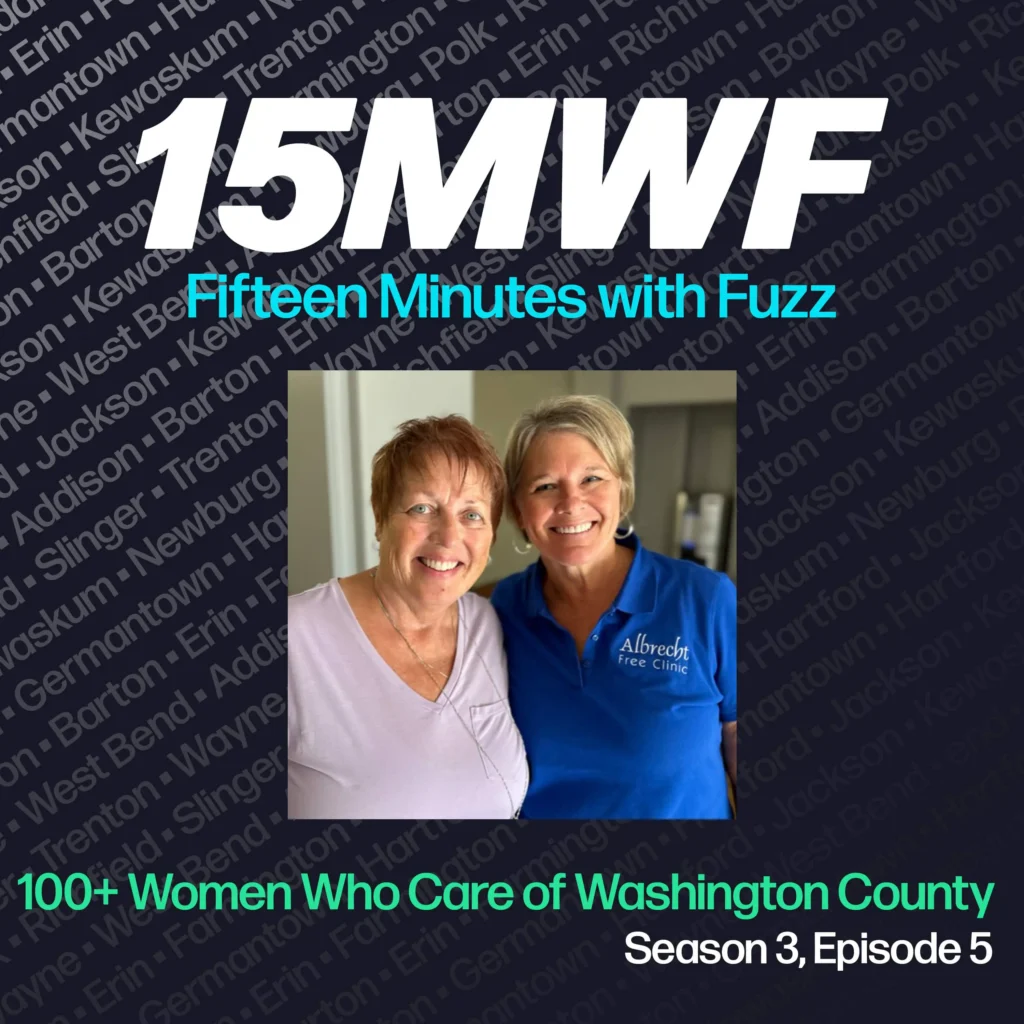 The cover art features a photo of two women, with one wearing an “Albrecht Free Clinic” shirt, symbolizing their involvement and support in the community. The podcast title “15MWF - Fifteen Minutes with Fuzz” is prominently displayed at the top. The background features a pattern of names of different locations within Washington County, emphasizing the local focus of the podcast. The episode title “100+ Women Who Care of Washington County” is written at the bottom, along with the season and episode number.
