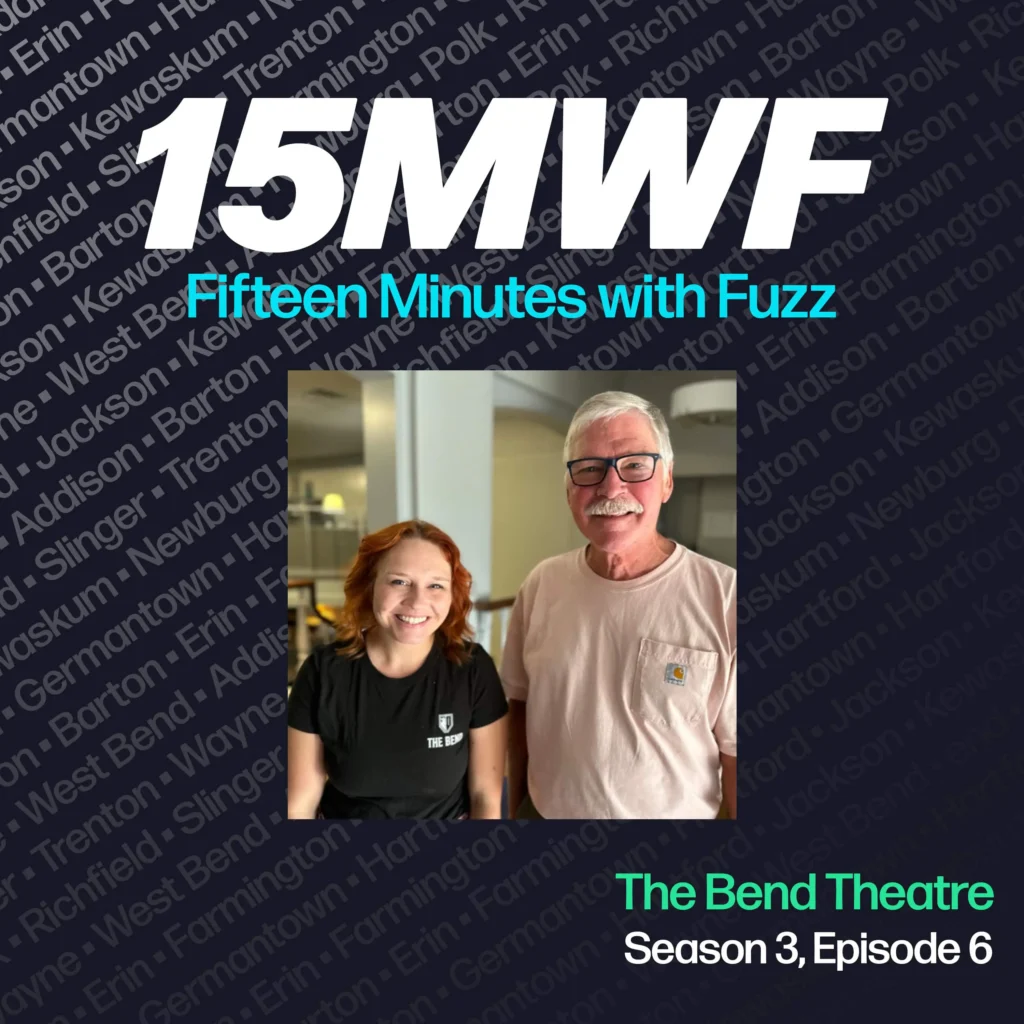 The cover art features a photo of two individuals, one wearing a shirt with “The Bend” logo, highlighting their connection to the theatre. The podcast title “15MWF - Fifteen Minutes with Fuzz” is prominently displayed at the top. The background features a pattern of names of different locations within Washington County, emphasizing the local focus of the podcast. The episode title “The Bend Theatre” is written at the bottom, along with the season and episode number.