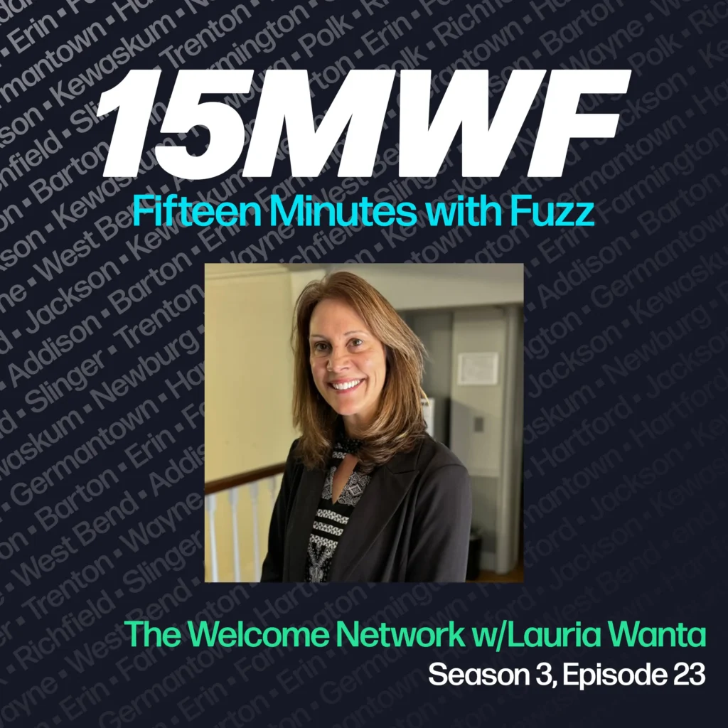 15MWF - Fifteen Minutes with Fuzz podcast cover art for Season 3, Episode 23 featuring The Welcome Network with Lauria Wanta. The background includes names of various locations within Washington County, emphasizing the local focus of the podcast. A photo of Lauria Wanta, smiling and wearing a black blazer over a patterned blouse, is placed in the center.