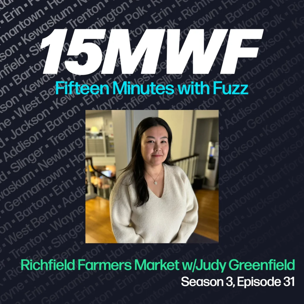 15MWF - Fifteen Minutes with Fuzz podcast cover art for Season 3, Episode 31 titled ‘Richfield Farmers Market w/ Judy Greenfield.’ The background includes names of various locations within Washington County, emphasizing the local focus of the podcast. A photo of Judy Greenfield, smiling and standing in an indoor setting, is placed in the center.