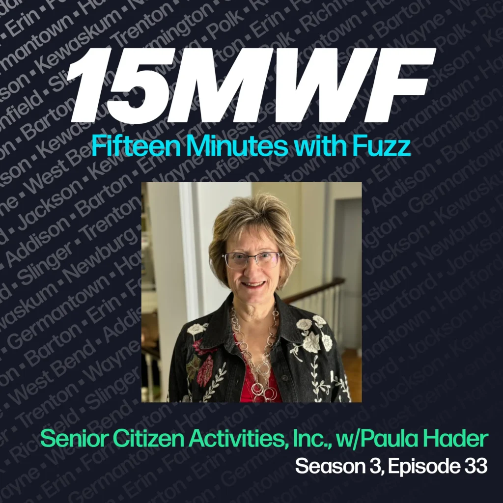 15MWF - Fifteen Minutes with Fuzz podcast cover art for Season 3, Episode 33 titled ‘Senior Citizen Activities, Inc., w/ Paula Hader.’ The background includes names of various locations within Washington County, emphasizing the local focus of the podcast. A photo of Paula Hader, smiling and wearing glasses, a black jacket with floral embroidery, and a necklace, is placed in the center.