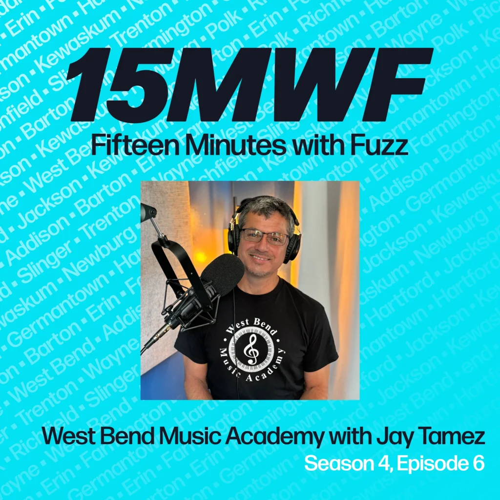 A square promotional graphic for the podcast “Fifteen Minutes with Fuzz.” The background is turquoise with a repeating pattern of town names. The top of the image features the “15MWF” logo, with “Fifteen Minutes with Fuzz” written below it. The bottom part of the image includes the episode title, “West Bend Music Academy with Jay Tamez,” and the text “Season 4, Episode 6.” On the left side, there is a photo of Jay Tamez, wearing a “West Bend Music Academy” t-shirt, sitting in front of a microphone in a podcast studio.