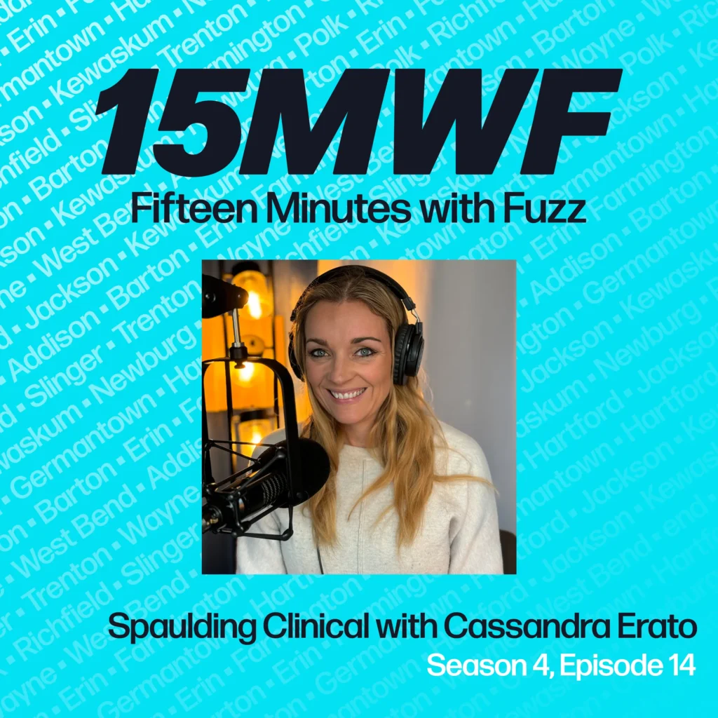 A square promotional graphic for “Fifteen Minutes with Fuzz,” featuring a teal background with various Wisconsin town names in light text. The top reads “15MWF” in bold black, followed by “Fifteen Minutes with Fuzz.” Below that is a photo of Cassandra Erato wearing headphones in a recording studio, smiling at the microphone. Text beneath the photo says “Spaulding Clinical with Cassandra Erato” and “Season 4, Episode 14.
